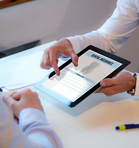 Patient reviewing dental insurance information on tablet