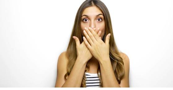 Woman covering her mouth with her hands