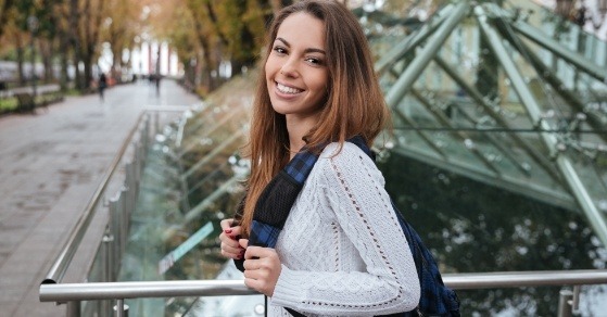 Brunette woman smiling on city street