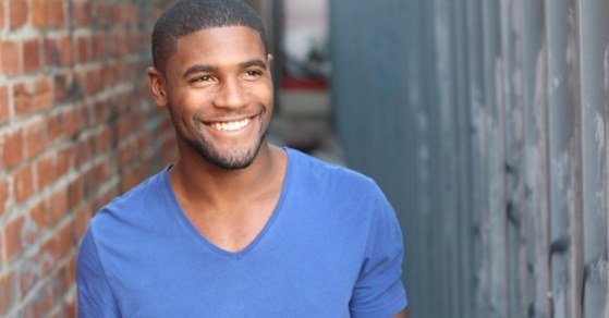 Smiling man in blue tee shirt