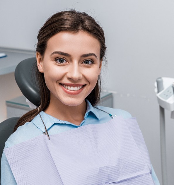 A smiling woman happy with her new tooth-colored fillings