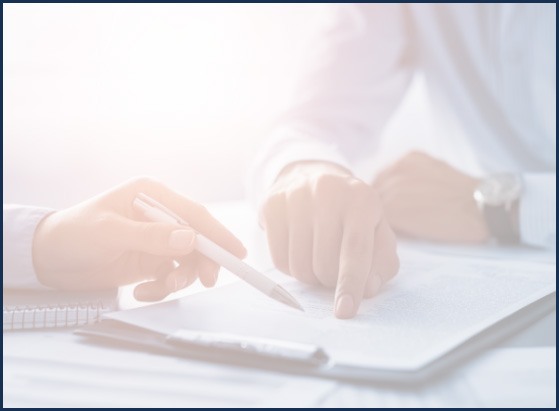 Two people looking at paper on clipboard