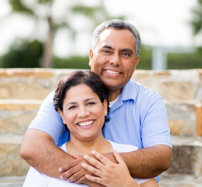 Smiling older couple after restorative dentistry in Waverly