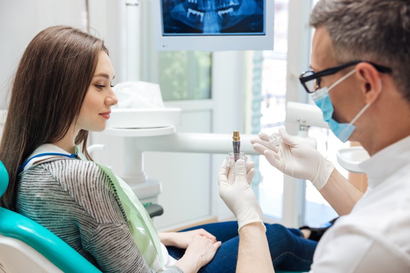 A dentist talking to a patient about implant safety