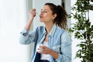 Woman enjoying a delicious bowl of yogurt